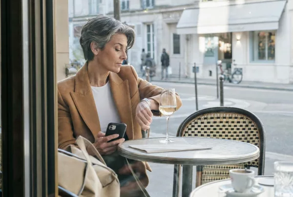 Femme consultant sa montre à la terrasse d’un café